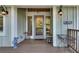 Inviting front porch with stylish decor, creating a welcoming entrance to the home at 4621 Lakeshore Dr, Pine Lake, GA 30072