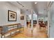 Hallway with hardwood floors, bench seating, and view of rooms and backyard at 4621 Lakeshore Dr, Pine Lake, GA 30072