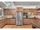 Bright kitchen features light wood cabinets, stainless steel appliances, and plenty of counter space at 4621 Lakeshore Dr, Pine Lake, GA 30072