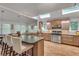 Bright and airy kitchen featuring hardwood floors, skylights, and stainless steel appliances at 4621 Lakeshore Dr, Pine Lake, GA 30072