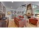 Bright living room featuring a stone fireplace, wooden flooring and large windows for sunlight at 4621 Lakeshore Dr, Pine Lake, GA 30072