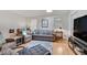 Cozy living room with ample natural light, neutral colors, hardwood floors, and comfortable seating at 4621 Lakeshore Dr, Pine Lake, GA 30072
