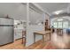 Open living space with hardwood floors, a stainless steel fridge, and natural light at 4621 Lakeshore Dr, Pine Lake, GA 30072