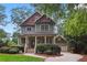 Charming two-story home with a covered front porch and beautifully landscaped front yard at 47 Oakridge Se Ave, Atlanta, GA 30317