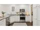 Bright kitchen with white cabinets, stainless steel appliances, and a geometric patterned rug at 47 Oakridge Se Ave, Atlanta, GA 30317