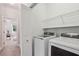 Well-equipped laundry room with modern washer and dryer units and convenient shelving for storage at 47 Oakridge Se Ave, Atlanta, GA 30317