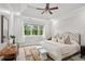 Spacious primary bedroom featuring a tray ceiling and a large window overlooking the backyard at 47 Oakridge Se Ave, Atlanta, GA 30317