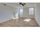 Spacious bedroom with two windows, ceiling fan, and wood-look flooring at 4735 Montane St, Cumming, GA 30028