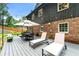 Outdoor living space features a dining table, lounge chairs, and backyard views at 1050 Lake Charles Dr, Roswell, GA 30075