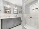 Bathroom with double vanity, framed mirrors, and hexagon tile flooring at 1050 Lake Charles Dr, Roswell, GA 30075