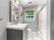 Updated bathroom with a sleek vanity, a glass-enclosed shower, and natural light from the window at 1050 Lake Charles Dr, Roswell, GA 30075