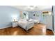 Light blue bedroom with two twin beds, a ceiling fan, hardwood floors, and natural light at 1050 Lake Charles Dr, Roswell, GA 30075