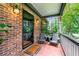 Inviting front porch with brick flooring and comfortable seating, perfect for enjoying the outdoors at 1050 Lake Charles Dr, Roswell, GA 30075