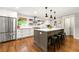 Modern kitchen with stainless steel appliances, white cabinets, and a spacious center island with seating at 1050 Lake Charles Dr, Roswell, GA 30075