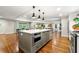 Open-concept kitchen featuring a large island, modern lighting, and seamless flow to the living area at 1050 Lake Charles Dr, Roswell, GA 30075