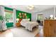 Main bedroom with an accent wall, hardwood floors, natural light, and a dedicated workspace at 1050 Lake Charles Dr, Roswell, GA 30075