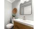 Stylish powder room featuring a modern vanity, a square mirror, and a decorative accent wall at 1050 Lake Charles Dr, Roswell, GA 30075
