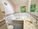 Bathroom featuring a soaking tub, and neutral color palette at 1333 Council Bluff Ne Dr, Atlanta, GA 30345