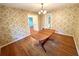 Traditional dining room with hardwood floors, decorative wallpaper, and vintage chandelier at 1333 Council Bluff Ne Dr, Atlanta, GA 30345