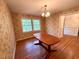Traditional dining room with hardwood floors, decorative wallpaper, and vintage chandelier at 1333 Council Bluff Ne Dr, Atlanta, GA 30345