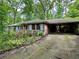 Charming single-story brick home with a carport and mature landscaping in a lush, green setting at 1333 Council Bluff Ne Dr, Atlanta, GA 30345