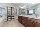 Bathroom boasts a double vanity, tile flooring, decorative mural, and ample storage space at 2727 Bearcreek Pl, Buford, GA 30519