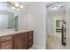 Bright bathroom featuring a modern vanity with wood cabinets and neutral countertop, plus tile flooring at 2727 Bearcreek Pl, Buford, GA 30519