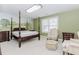 Bedroom with decorative mural, four poster bed and ensuite bathroom at 2727 Bearcreek Pl, Buford, GA 30519