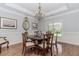 An elegant dining room with hardwood floors, chandelier, and wainscoting providing a classic touch at 2727 Bearcreek Pl, Buford, GA 30519