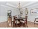 An elegant dining room with hardwood floors, chandelier, and wainscoting providing a classic touch at 2727 Bearcreek Pl, Buford, GA 30519