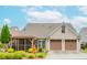 Well-maintained home with a two-car garage, screened porch, and beautifully landscaped front yard at 2727 Bearcreek Pl, Buford, GA 30519
