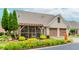 Well-maintained home with a two-car garage, screened porch, and mature landscaping at 2727 Bearcreek Pl, Buford, GA 30519