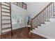 Foyer featuring hardwood floors, staircase with iron spindles, and decorative transom windows above the double doors at 2727 Bearcreek Pl, Buford, GA 30519