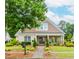 Charming, brick home featuring manicured landscaping, a walkway, and a welcoming front porch at 2727 Bearcreek Pl, Buford, GA 30519