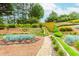 Multi-tiered garden features stone steps and walking path, with colorful flowers and green shrubbery at 2727 Bearcreek Pl, Buford, GA 30519