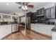 A kitchen with stainless steel appliances, dark and white cabinets, hardwood floors and smooth, dark countertops at 2727 Bearcreek Pl, Buford, GA 30519