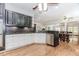 Open concept kitchen features stainless steel appliances, hardwood floors, and dark and white cabinetry at 2727 Bearcreek Pl, Buford, GA 30519