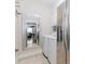 Convenient laundry room featuring a washer, dryer, and stainless steel refrigerator at 2727 Bearcreek Pl, Buford, GA 30519