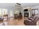 Living room with hardwood floors, natural light, fireplace, and a comfortable seating area at 2727 Bearcreek Pl, Buford, GA 30519