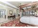 Spacious main bedroom featuring a four-poster bed, decorative rug, and en-suite bathroom access at 2727 Bearcreek Pl, Buford, GA 30519