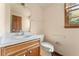 Modest bathroom featuring vanity with storage, toilet, and natural light from window at 4354 Revere Cir, Marietta, GA 30062