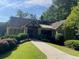 Charming single-story home with lush landscaping, a walkway, and a Tudor-style entry at 4354 Revere Cir, Marietta, GA 30062