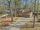 Inviting two-story home showcasing a two-car garage and a long driveway surrounded by mature trees at 4354 Revere Cir, Marietta, GA 30062