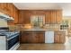 Classic eat-in kitchen featuring wood cabinetry, tile floors, and stainless steel oven range at 4354 Revere Cir, Marietta, GA 30062