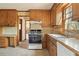 Functional kitchen with wooden cabinets, neutral tile flooring, and a window with natural light at 4354 Revere Cir, Marietta, GA 30062