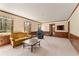 Cozy living room featuring carpeted floors, wood paneling, and generous natural light at 4354 Revere Cir, Marietta, GA 30062