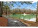 Scenic community pond with a fountain in the center and a walking path alongside the water's edge at 4354 Revere Cir, Marietta, GA 30062