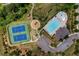 An aerial view showing a tennis court, playground, community pool, clubhouse, and parking area at 6110 Read Rd, Suwanee, GA 30024
