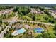 A scenic aerial view features a community pool, tennis courts, and surrounding neighborhood at 6110 Read Rd, Suwanee, GA 30024