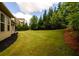 Lush backyard with mature trees, manicured lawn, and privacy, offering a serene outdoor space at 6110 Read Rd, Suwanee, GA 30024